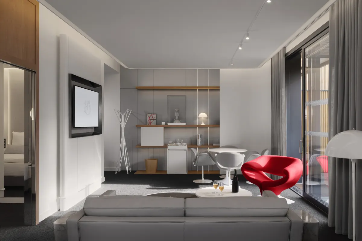 Le salon d’une suite privative du salon La Première avec canapé, table et écran