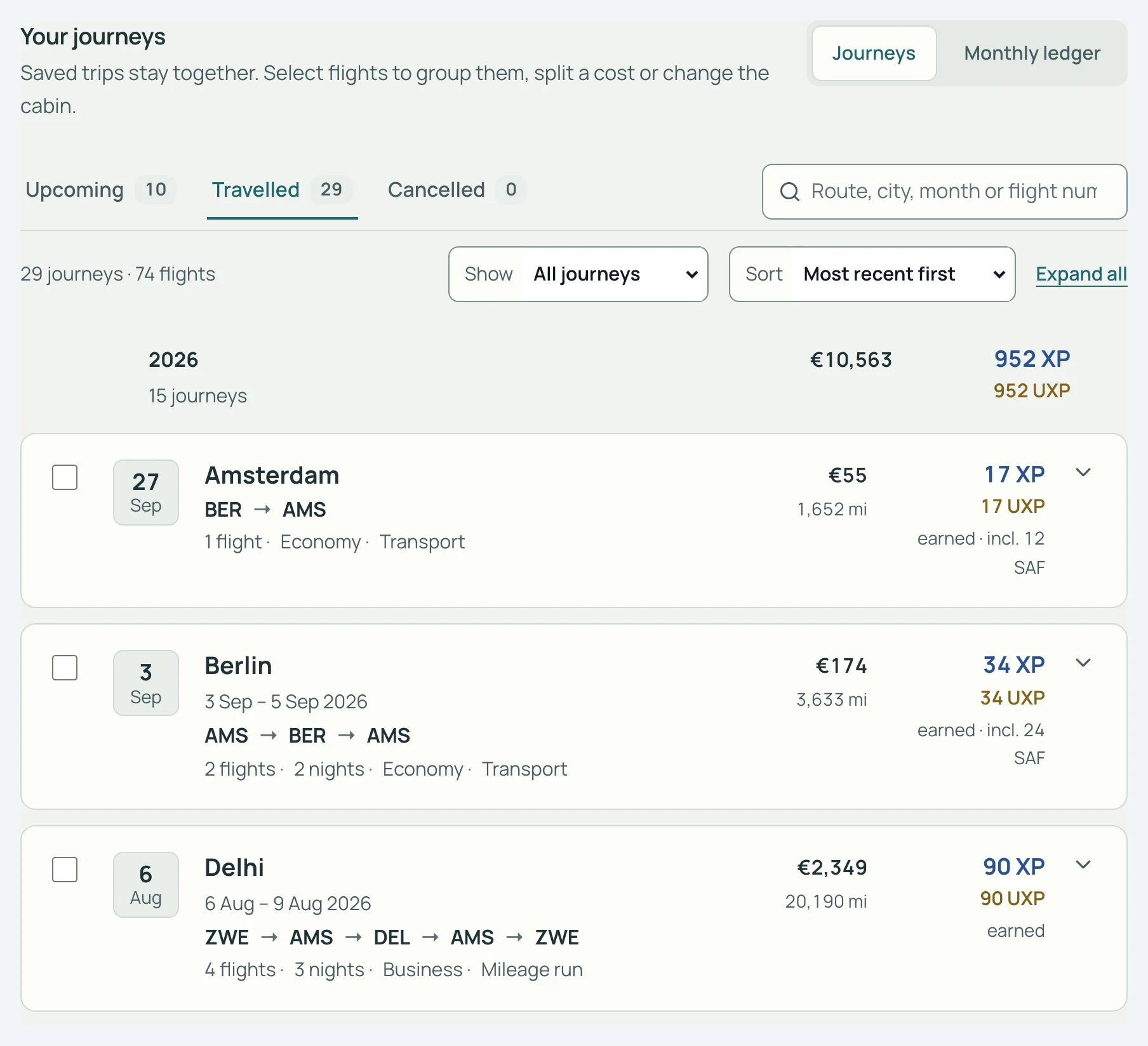 SkyStatus Flights, Travelled tab with 29 journeys and 74 flights: the 2026 group totals €10,563 and 952 XP, Delhi marked as a mileage run.